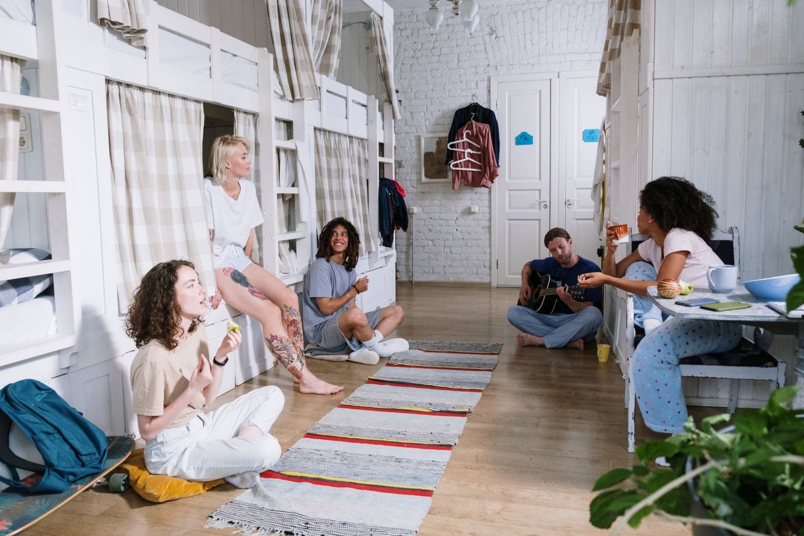 Friends together inside a hostel dormitory